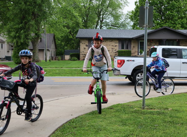  Three students ride on their bike to school